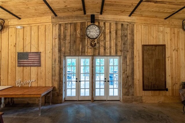 doorway with wood ceiling, wood walls, vaulted ceiling, and french doors