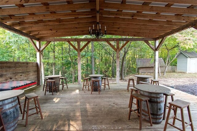 view of patio / terrace with a deck, a pergola, and a storage unit