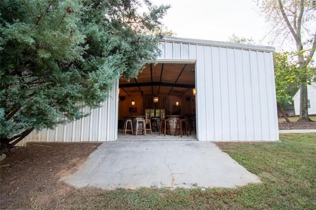 view of outbuilding featuring a lawn