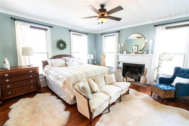 bedroom featuring ornamental molding, ceiling fan, and hardwood / wood-style flooring