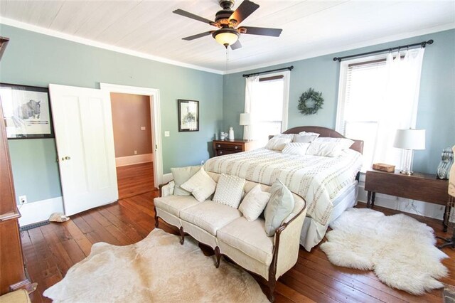 bedroom with ceiling fan, wooden ceiling, dark wood-type flooring, and crown molding