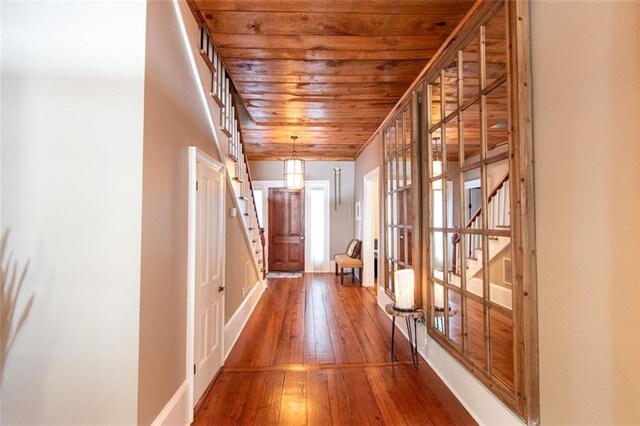 corridor with wood ceiling and hardwood / wood-style floors