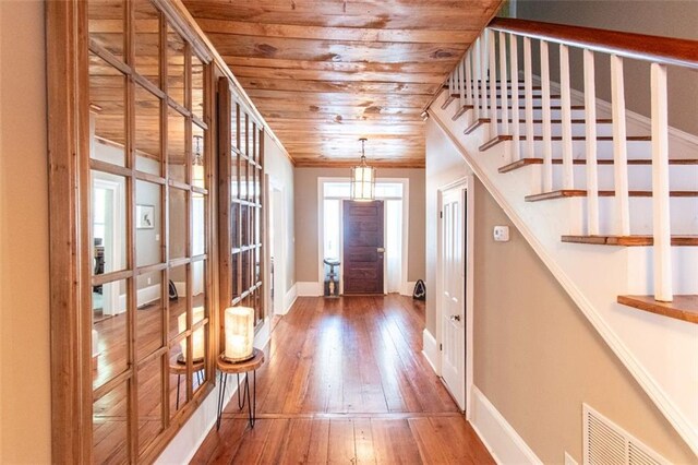 entrance foyer featuring hardwood / wood-style flooring and wood ceiling