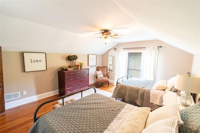 bedroom featuring vaulted ceiling, hardwood / wood-style floors, and ceiling fan