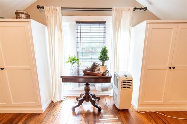 interior space featuring lofted ceiling and dark wood-type flooring