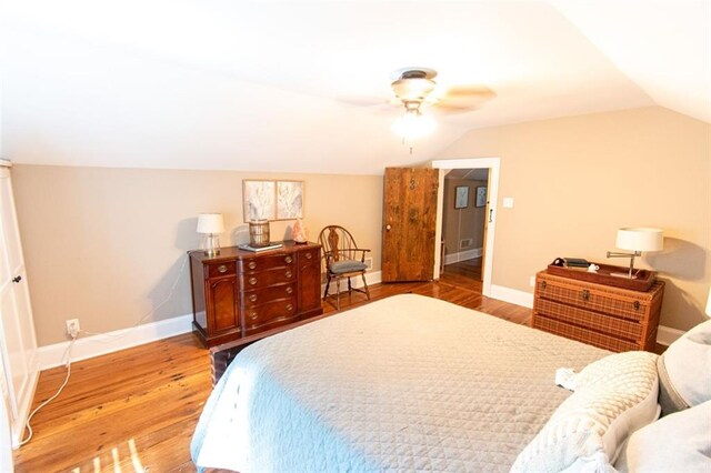 bedroom featuring vaulted ceiling, ceiling fan, and hardwood / wood-style flooring