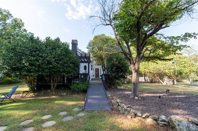 view of front of house featuring a front yard and a deck