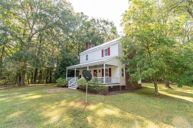 country-style home featuring a front yard and a porch