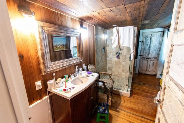 bathroom featuring wood ceiling, an enclosed shower, wood walls, hardwood / wood-style floors, and vanity