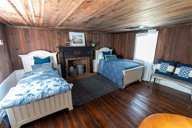 bedroom featuring wood ceiling, wood walls, and dark wood-type flooring