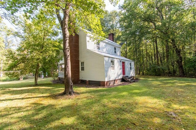 view of side of property with a lawn