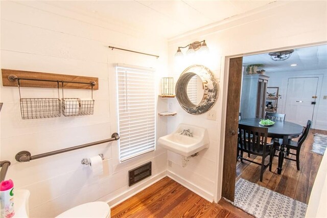 bathroom with sink, hardwood / wood-style flooring, and toilet