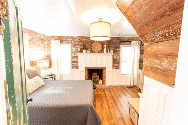 bedroom featuring light wood-type flooring and vaulted ceiling