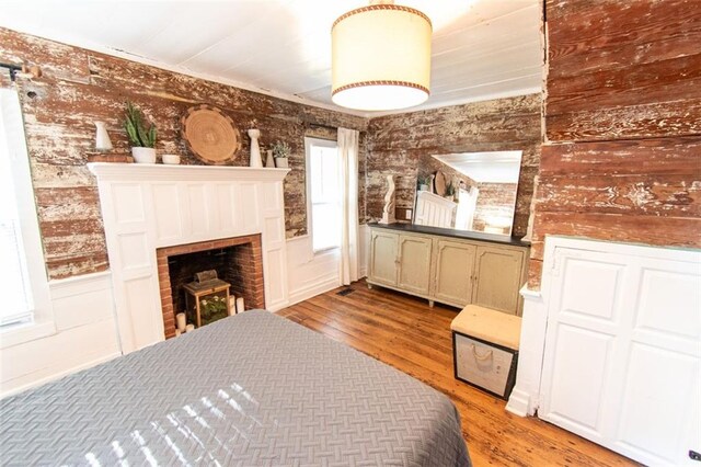 bedroom featuring light hardwood / wood-style flooring and a fireplace