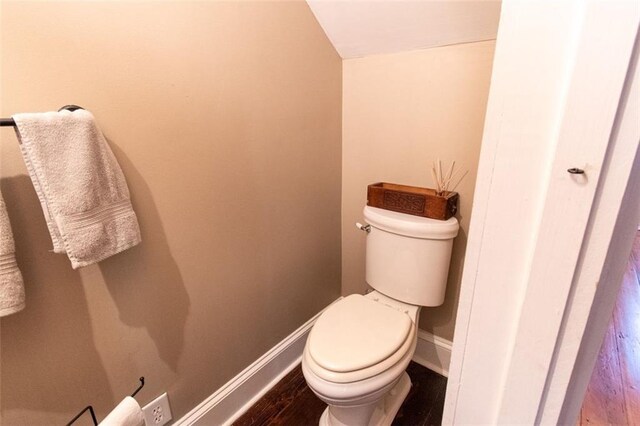 bathroom with wood-type flooring and toilet