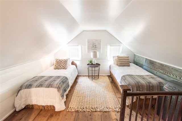 bedroom featuring wood-type flooring and lofted ceiling