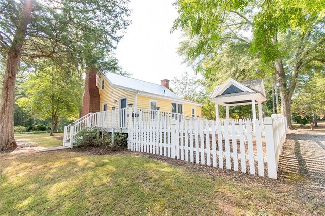 view of side of home with a lawn