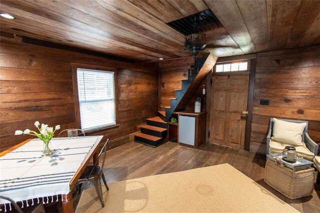 interior space with wooden walls, dark wood-type flooring, and wooden ceiling