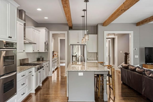 970 N Ormewood Park Dr SE, Atlanta, GA 30316 - kitchen featuring stainless steel appliances, beam ceiling, a sink, tasteful backsplash, and dark wood-style flooring