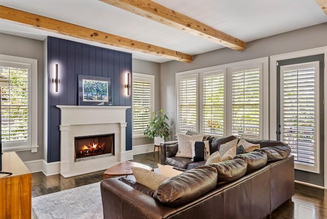 970 N Ormewood Park Dr SE, Atlanta, GA 30316 - living room featuring beam ceiling, a fireplace, healthy amount of natural light, baseboards, and dark wood-type flooring