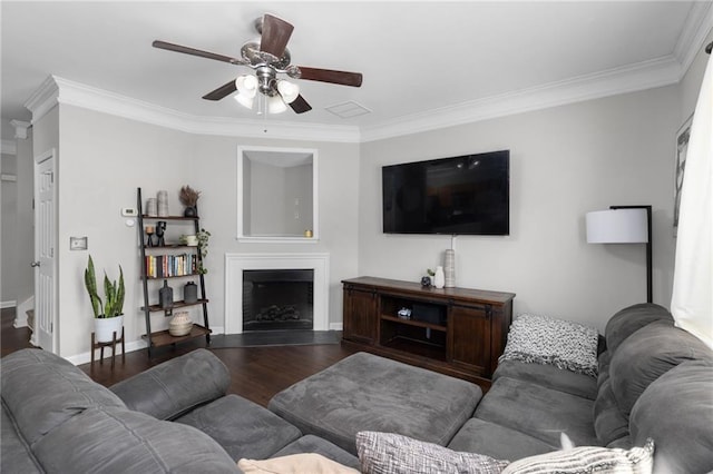 living room with ceiling fan, ornamental molding, and dark hardwood / wood-style flooring