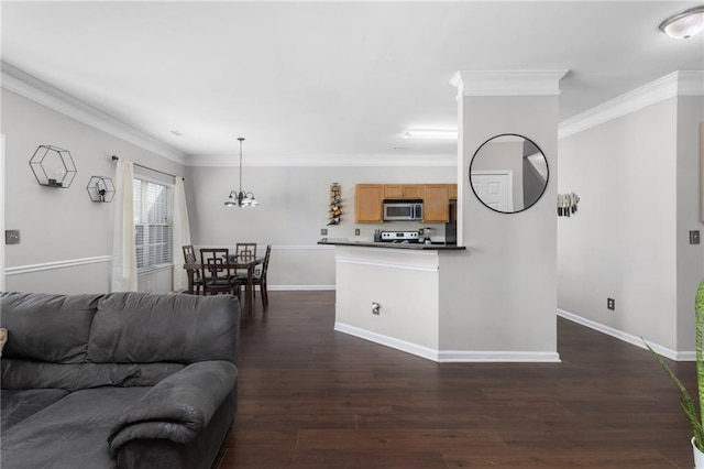 living room featuring dark hardwood / wood-style flooring, crown molding, and an inviting chandelier