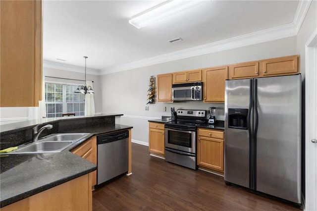 kitchen featuring pendant lighting, sink, ornamental molding, and stainless steel appliances