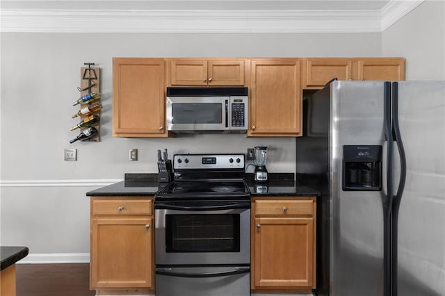 kitchen with ornamental molding, appliances with stainless steel finishes, and dark stone counters