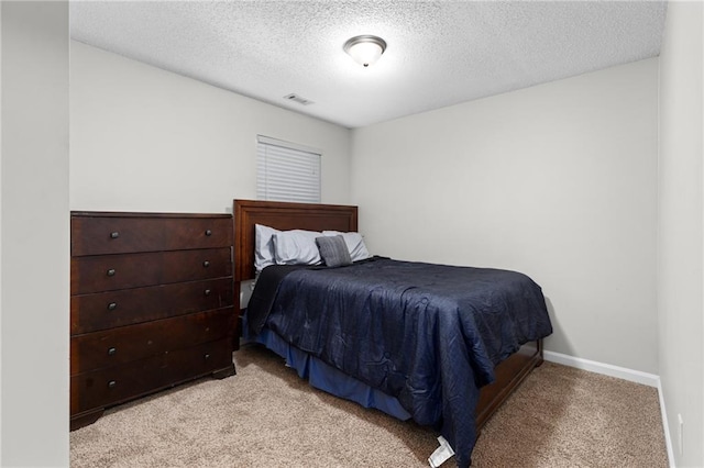 carpeted bedroom with a textured ceiling