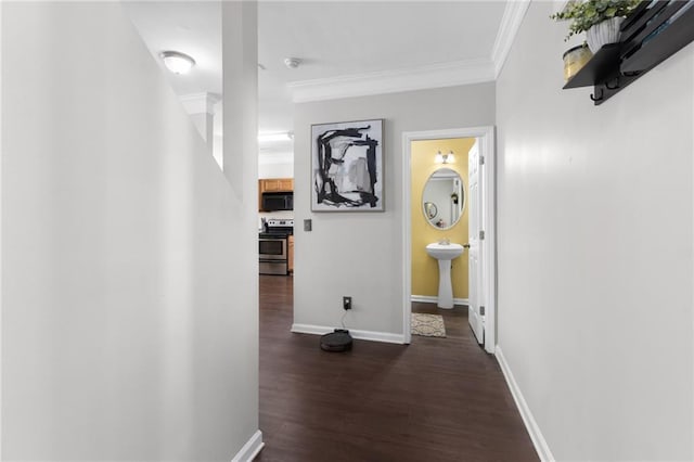 hall featuring ornamental molding and dark hardwood / wood-style floors