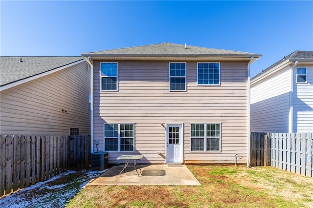 rear view of house with a patio, central AC unit, and a lawn