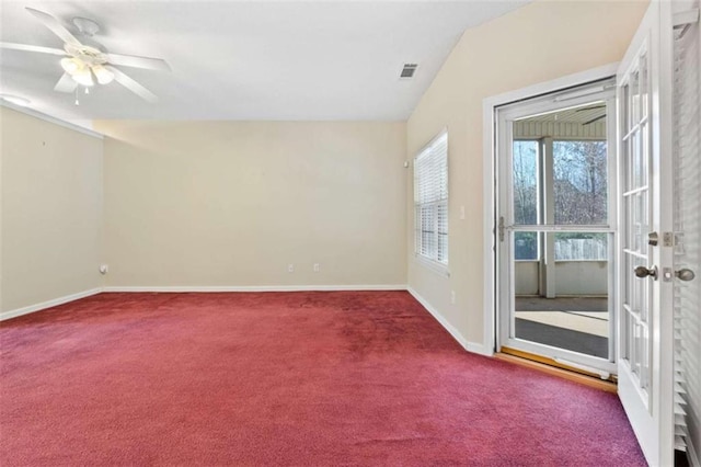 carpeted spare room with vaulted ceiling