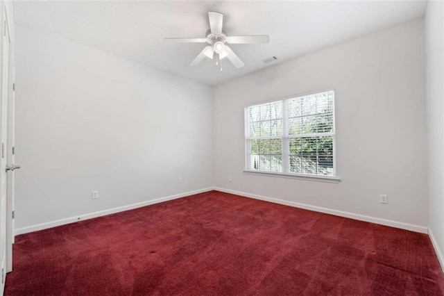 carpeted empty room featuring ceiling fan