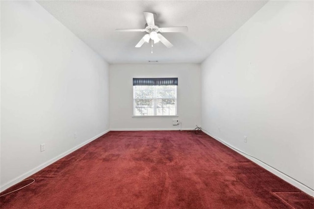 unfurnished room featuring ceiling fan and carpet