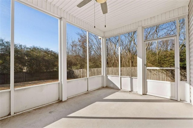 unfurnished sunroom with a healthy amount of sunlight and ceiling fan