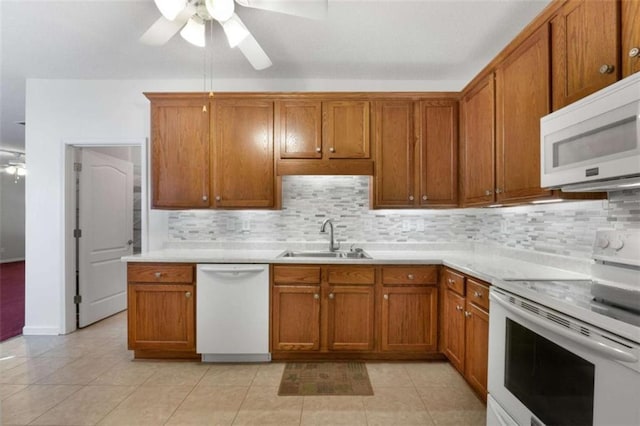 kitchen with light tile patterned floors, sink, white appliances, ceiling fan, and decorative backsplash