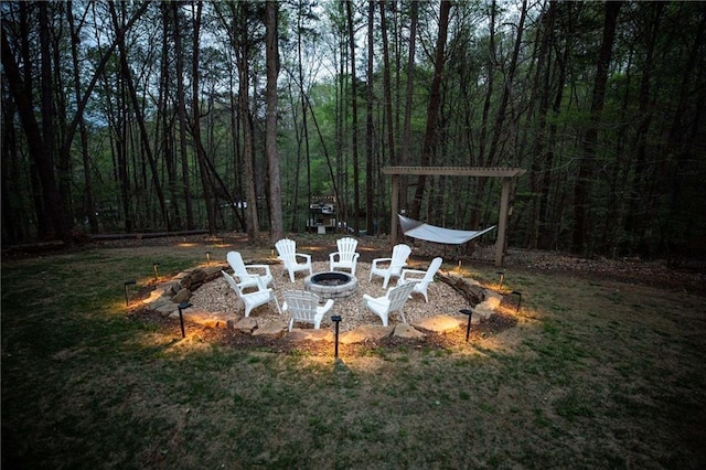 view of yard with a fire pit and a pergola