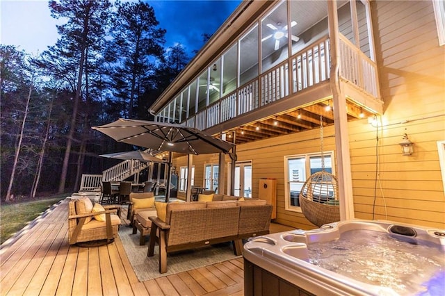 deck with outdoor lounge area and a hot tub