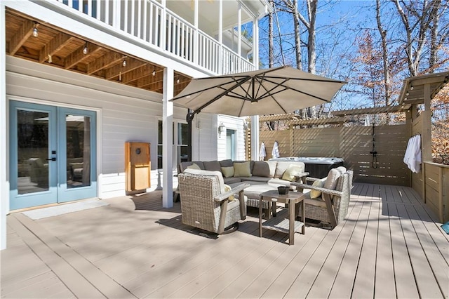 rear view of property featuring a lawn, french doors, outdoor dining area, and a balcony