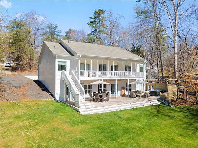 rear view of house with an outdoor living space, a yard, and a wooden deck