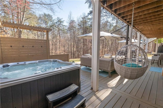 wooden deck featuring hot tub deck surround