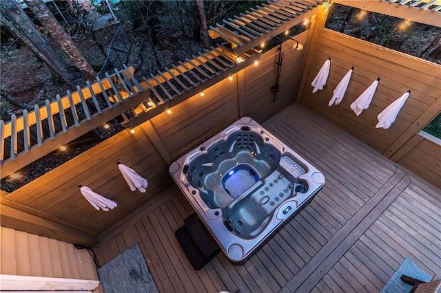 wooden deck featuring hot tub deck surround