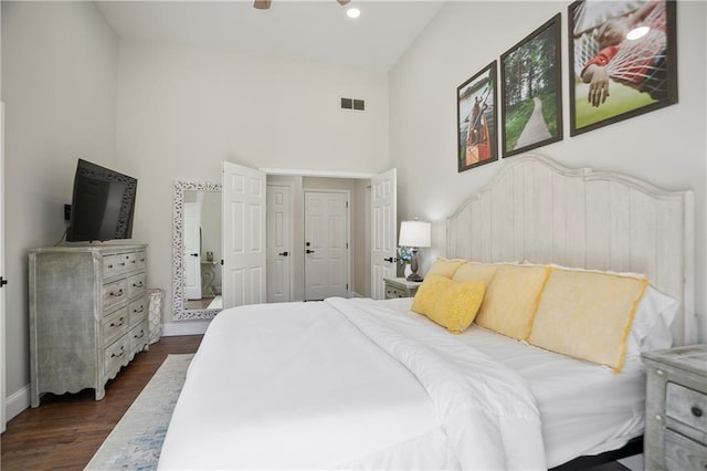 bedroom featuring wood finished floors, recessed lighting, baseboards, and visible vents