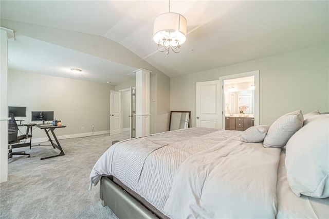 carpeted bedroom with an inviting chandelier, lofted ceiling, and connected bathroom