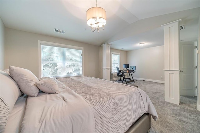 bedroom featuring decorative columns, vaulted ceiling, and light carpet