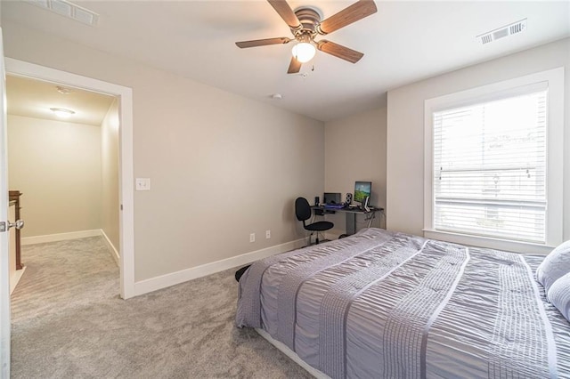 bedroom with ceiling fan and light carpet