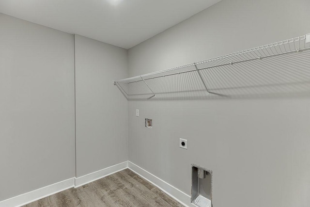 laundry area with washer hookup, electric dryer hookup, wood finished floors, laundry area, and baseboards