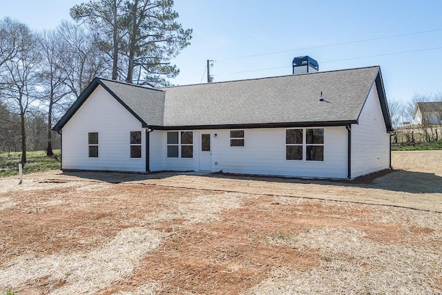 back of property featuring a shingled roof