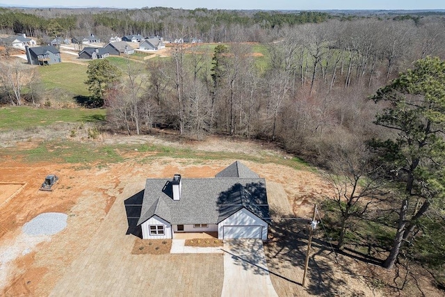 drone / aerial view with a wooded view