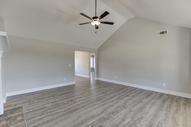 empty room featuring baseboards, visible vents, a ceiling fan, wood finished floors, and high vaulted ceiling